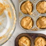 banana pumpkin muffin batter in a muffin tin.