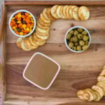 reese's pieces and crackers on a snack board.