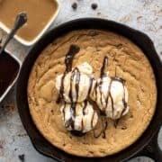 a pizookie on a counter with melting ice cream.