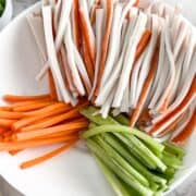 julienned carrots, cucumbers and crab in a bowl.
