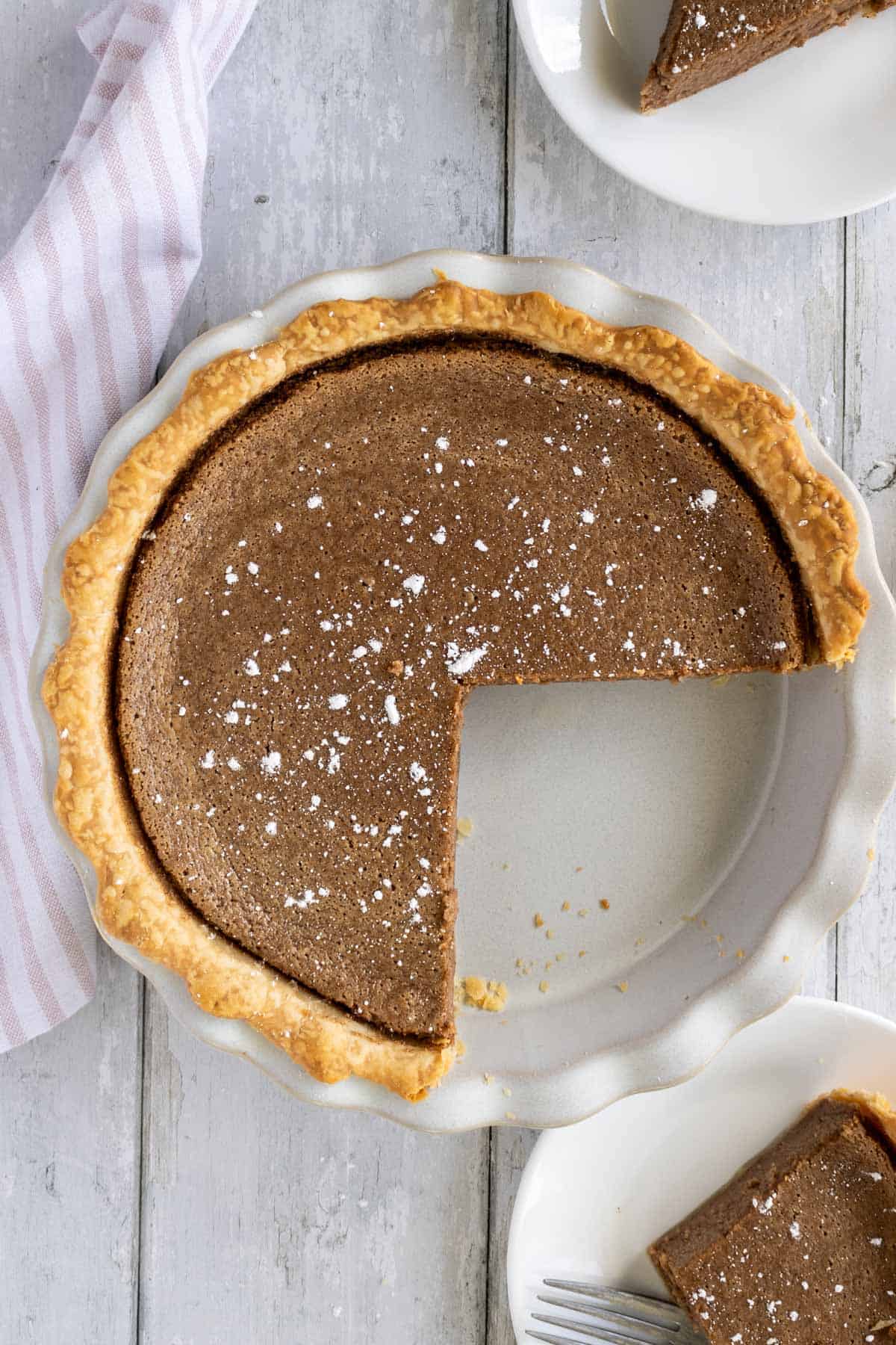 Above shot of whole cinnamon pie with a missing piece.