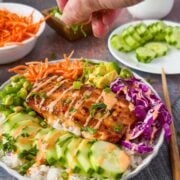 Salmon bowl with veggies and sauce.