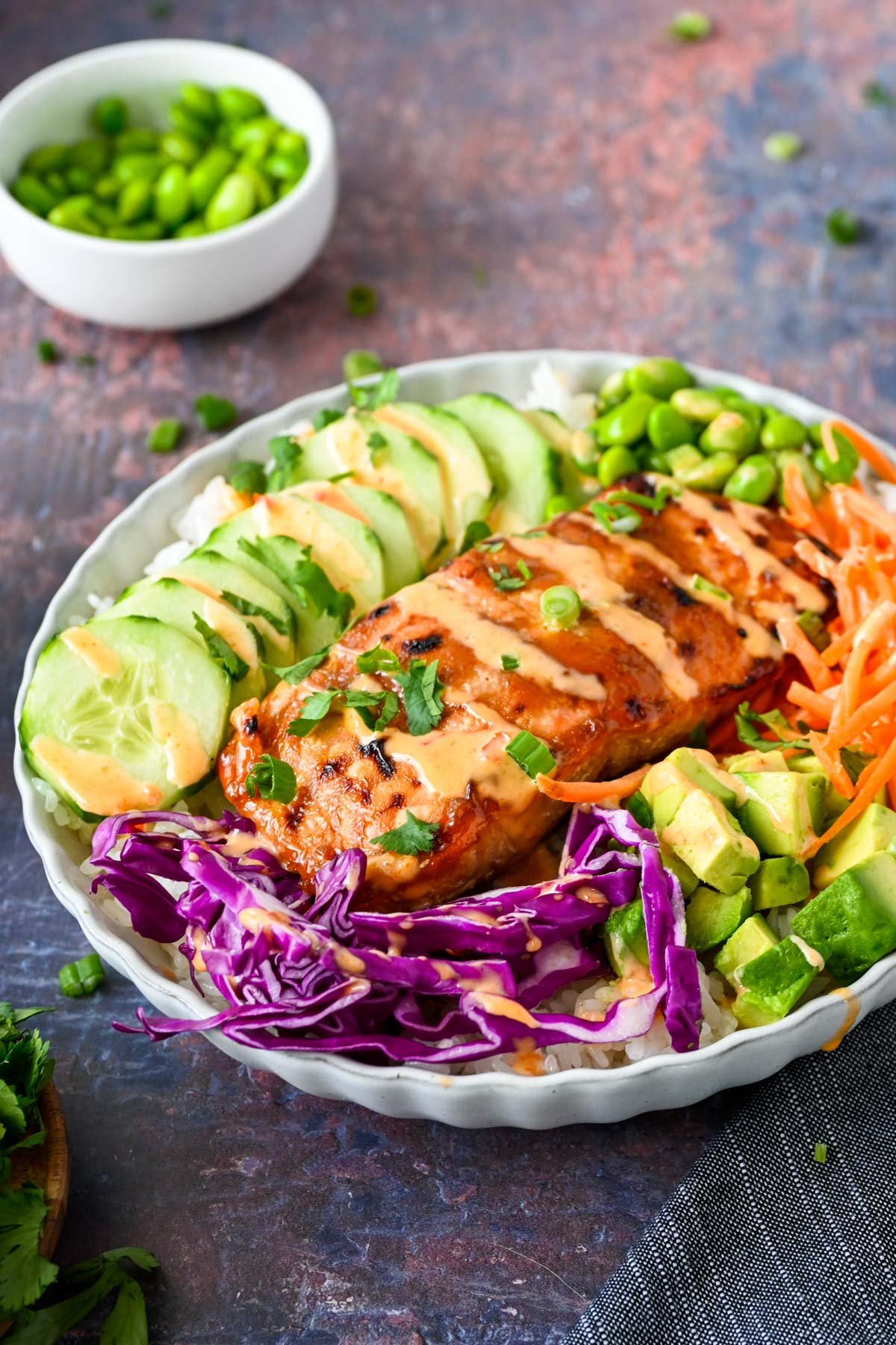 Salmon bowl with veggies and sauce.