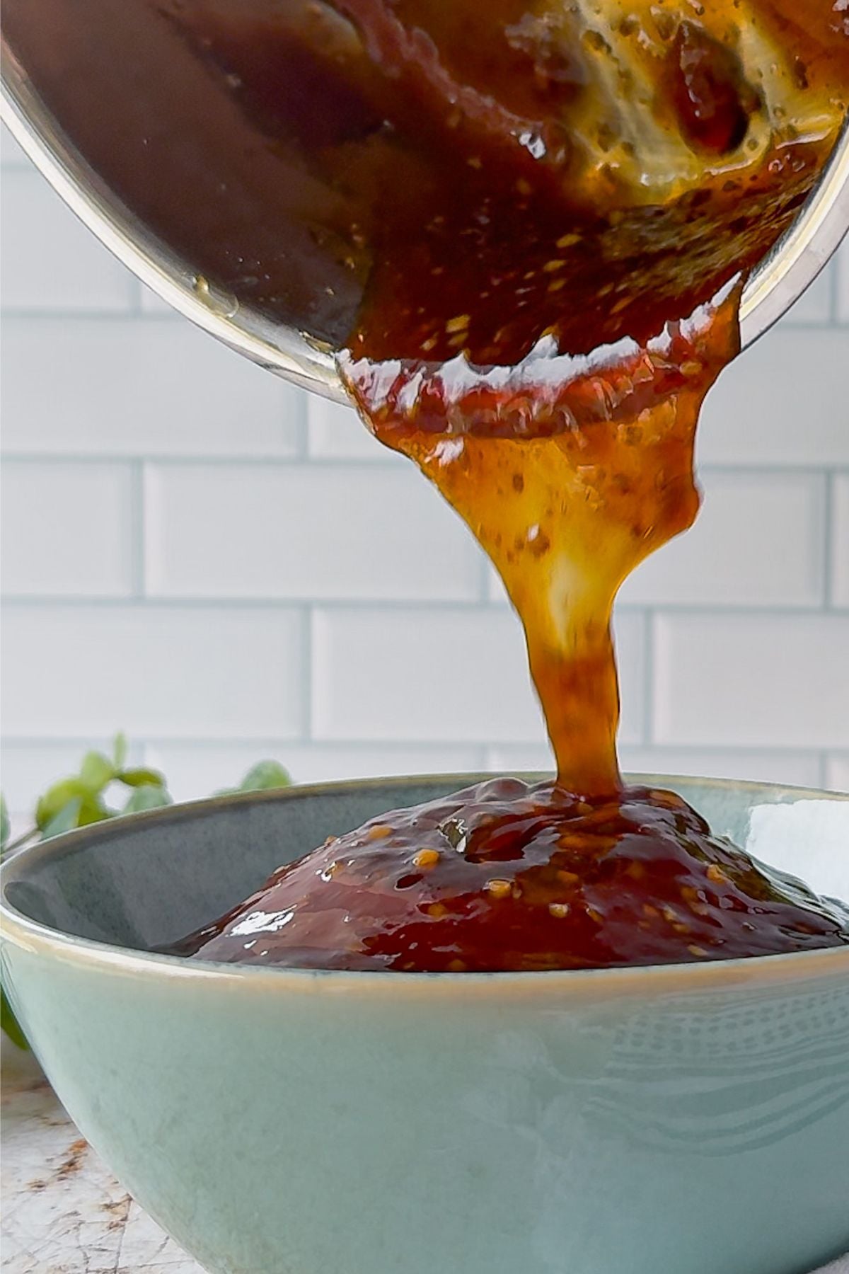 Pouring a bowl of teriyaki sauce.