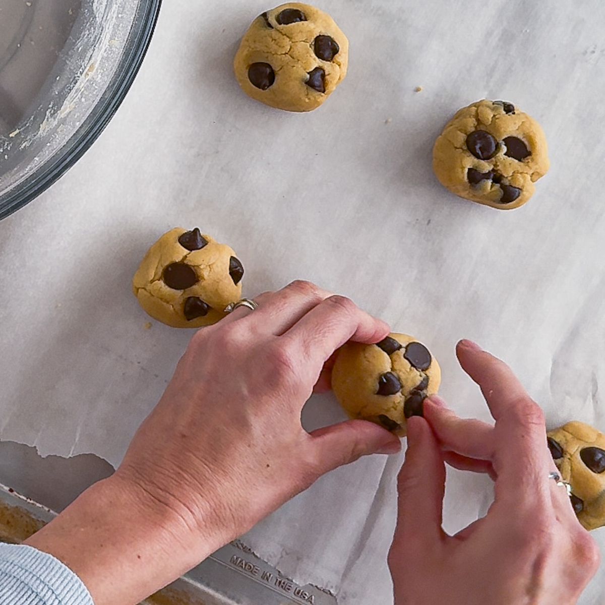 Placing the dough balls on the pan.