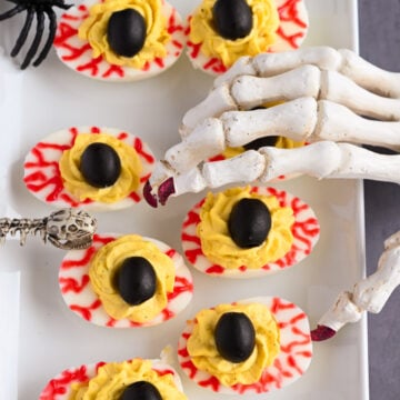 Halloween deviled eggs to look like eyes.
