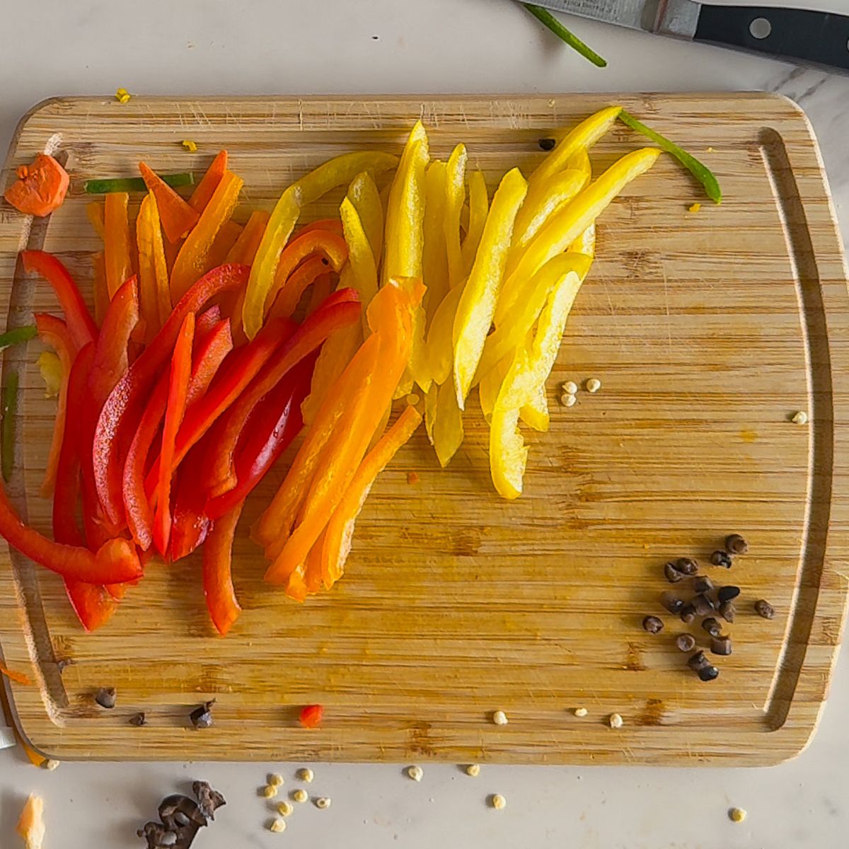 Cut bell peppers, carrots, and olives.