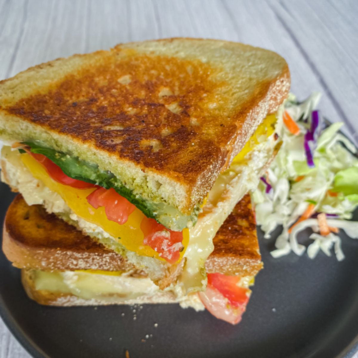 a chicken pesto panini on a plate.