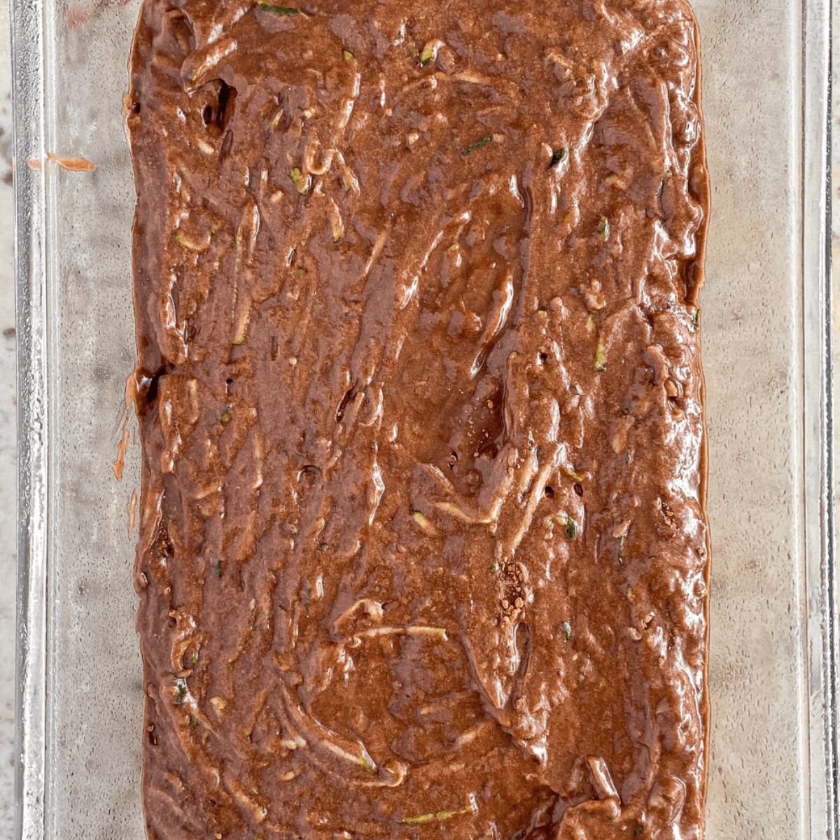 chocolate zucchini bread batter in a bread pan.