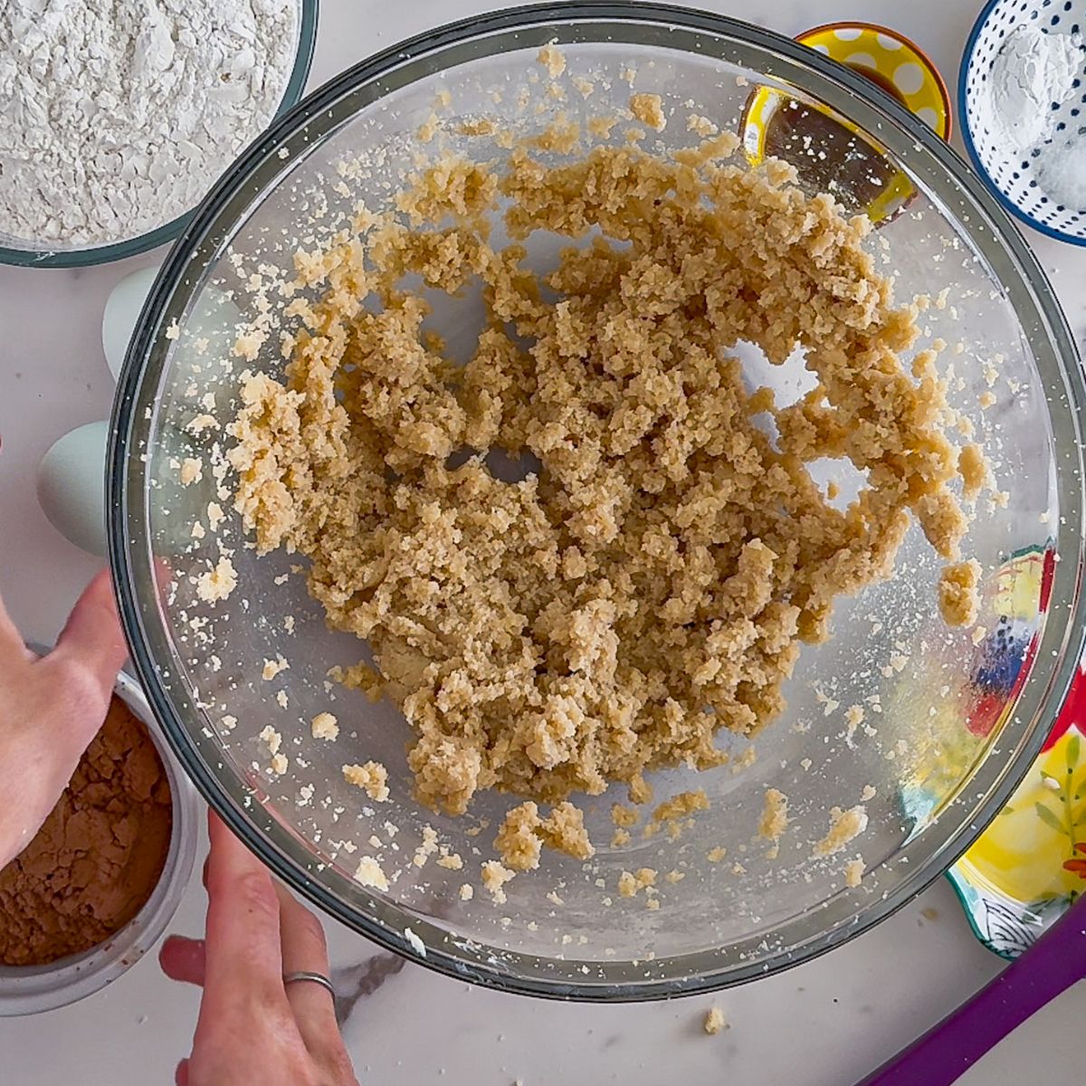 Mixing the sugar and butter together in a bowl. 