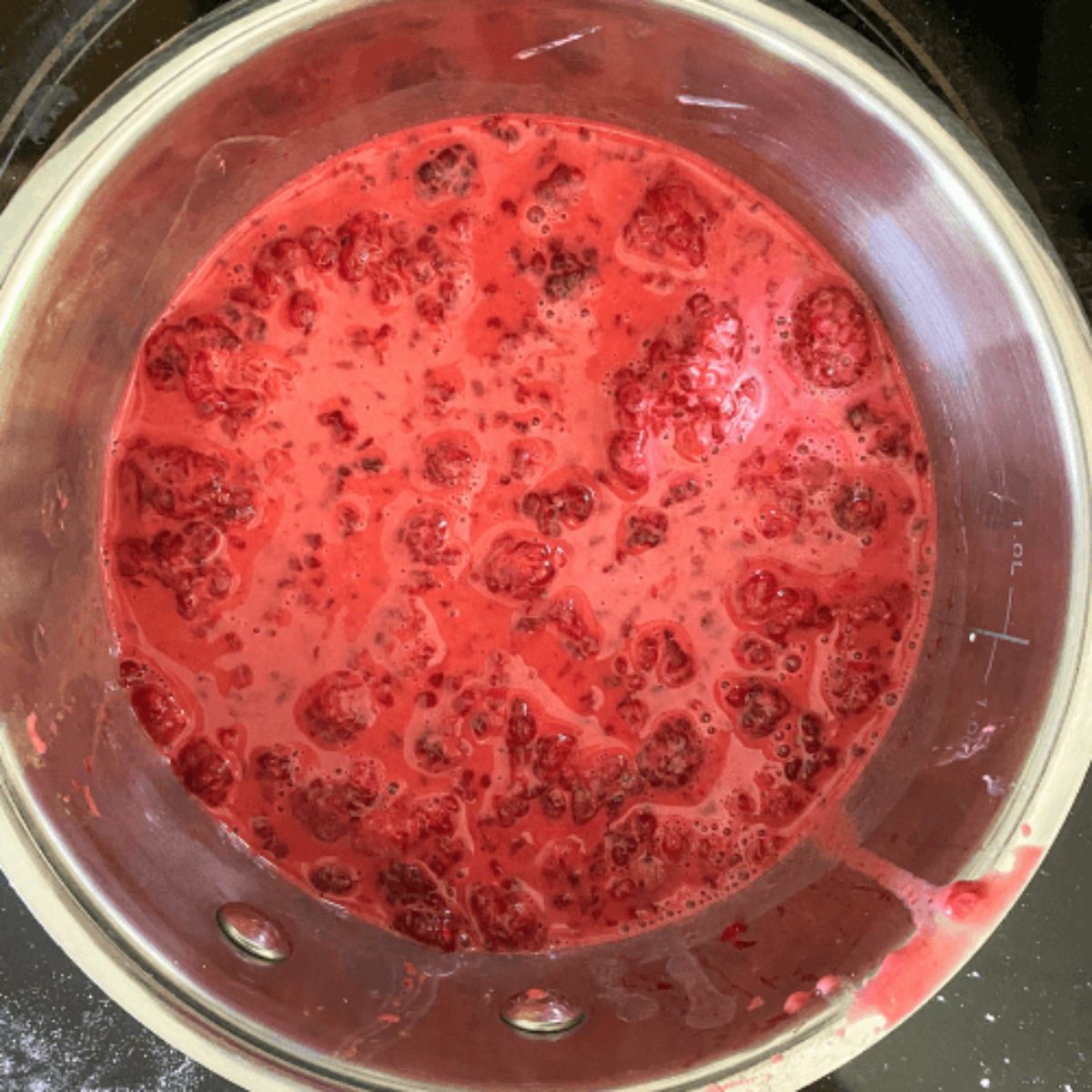 raspberries cooking in a saucepan.