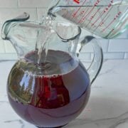 Adding ingredients for halloween punch.