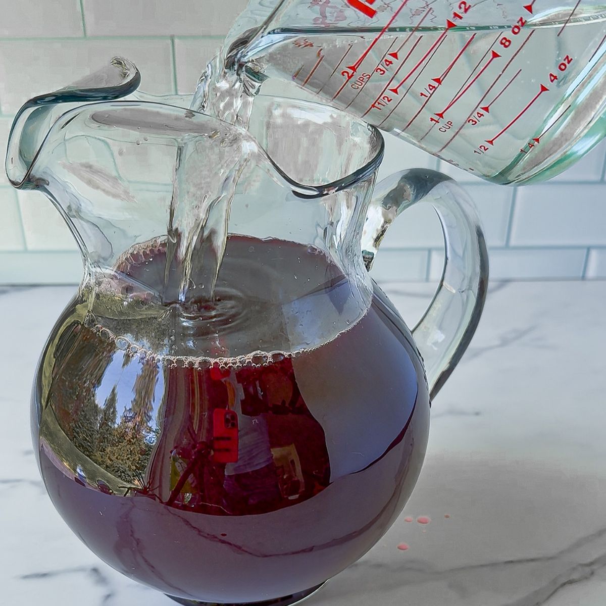 Adding ingredients for halloween punch.