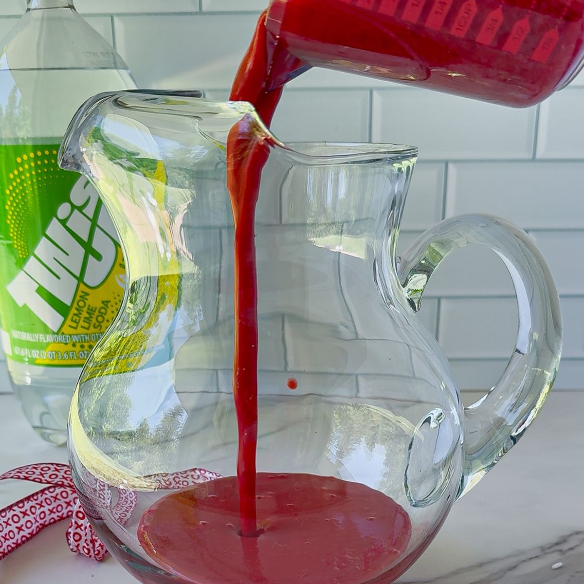 Added the puree raspberries to a pitcher.