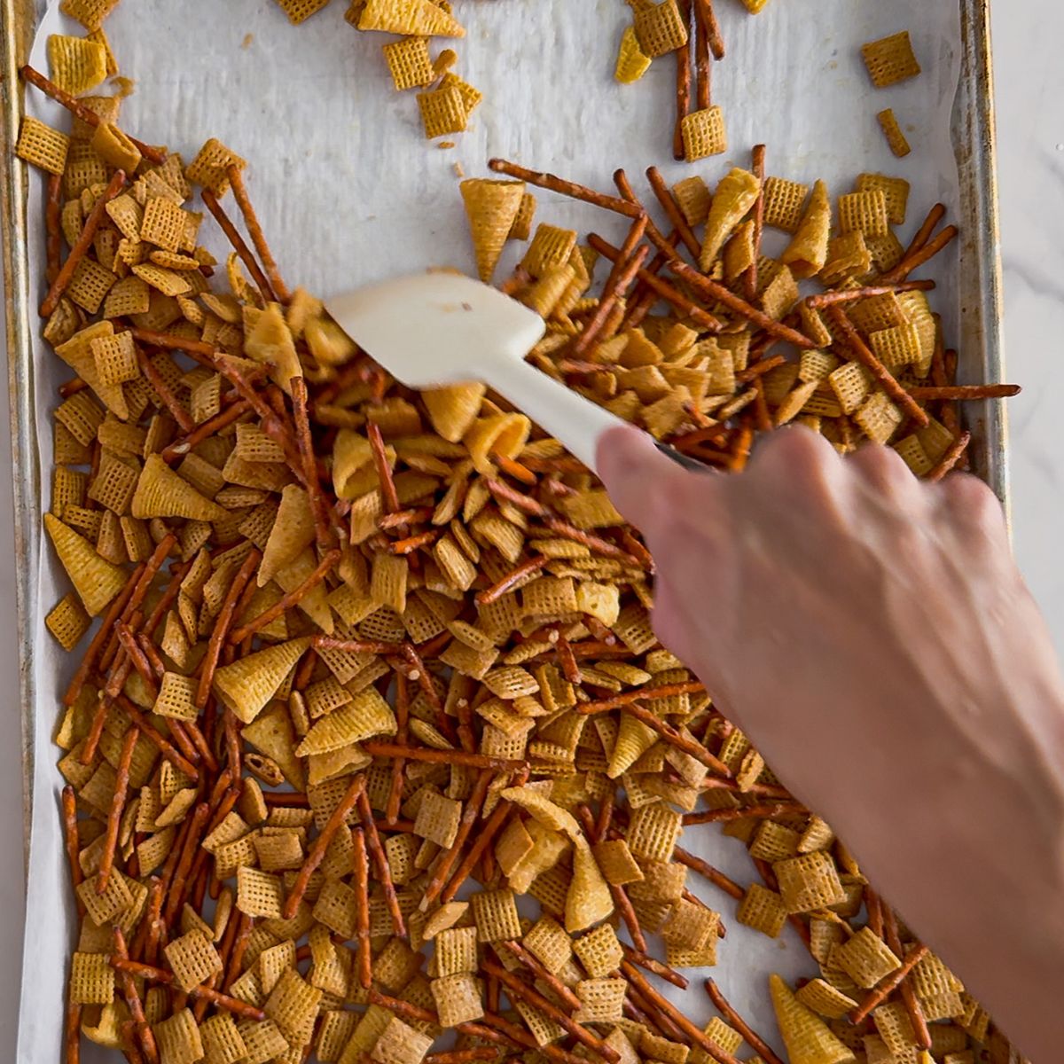 Baking the base of the halloween chex snack mix.