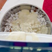 Pouring in the melted marshmallow mixture.