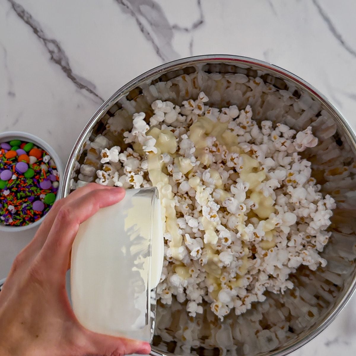 Pouring on the melted white chocolate.