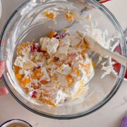 Mixing the fruit into ambrosia salad.