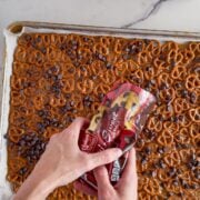 Adding the chocolate to the pretzels.