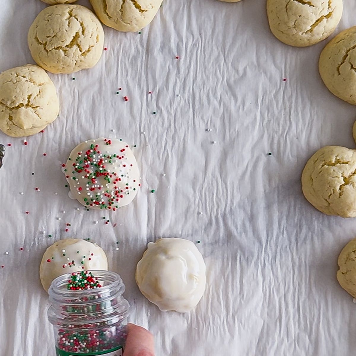 Sprinkle the italian christmas cookies with festive sprinkles.