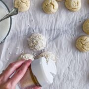 Adding sprinkles to an Italian wedding cookie.