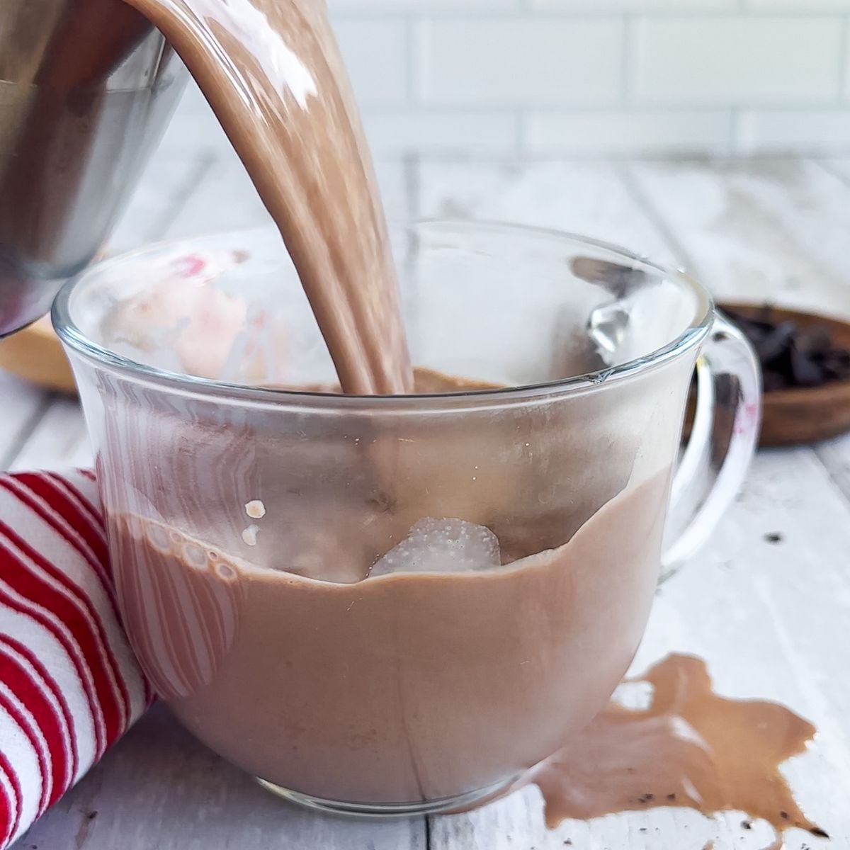 Pouring a glass of peppermint hot chocolate.