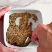 Mixing philly cheesesteak seasoning.