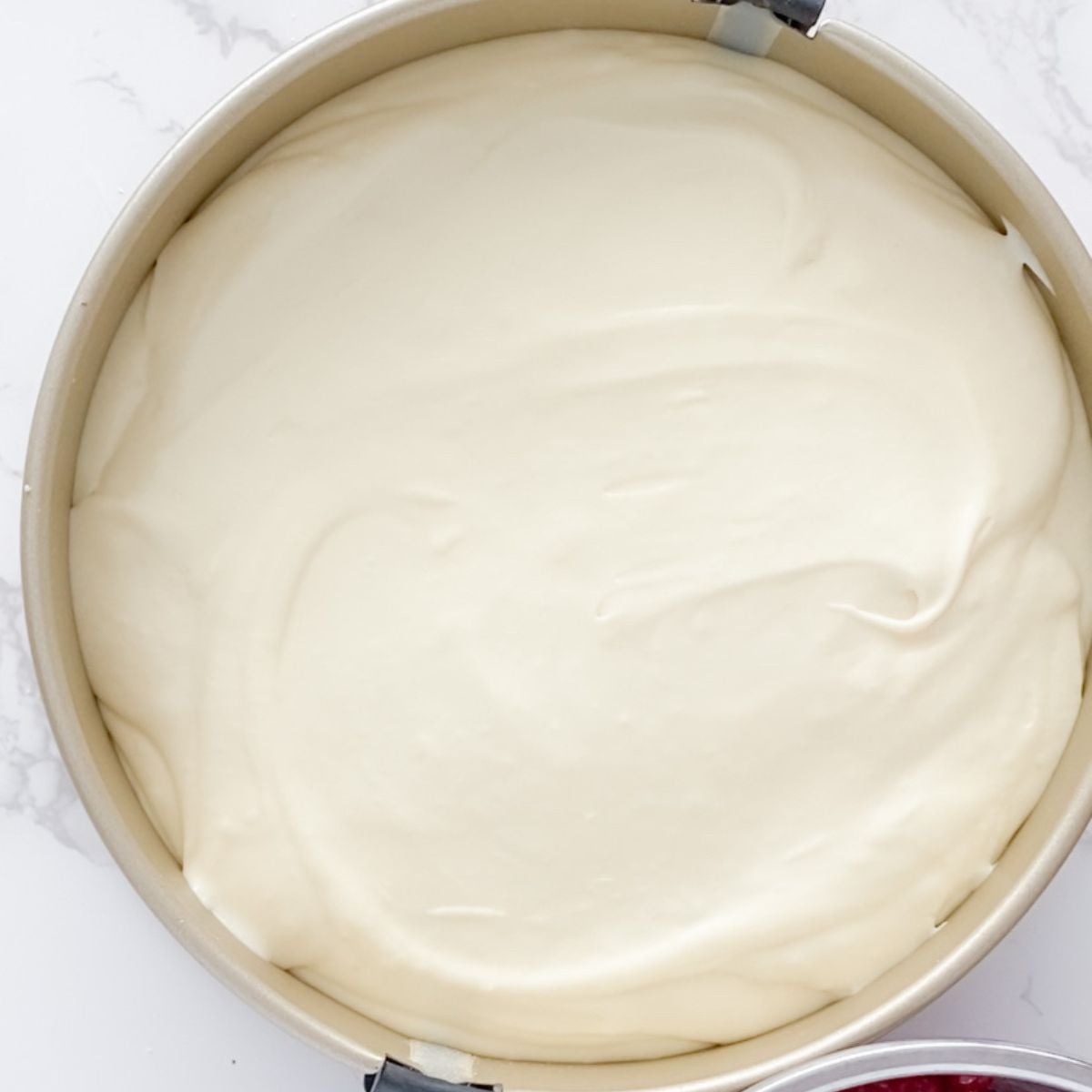 Adding the batter to a springform pan.