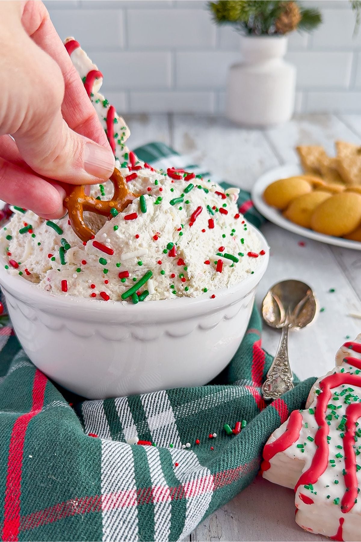 Dipping a pretzel into the Little Debbie dip.