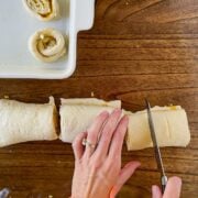 Cutting the orange rolls.