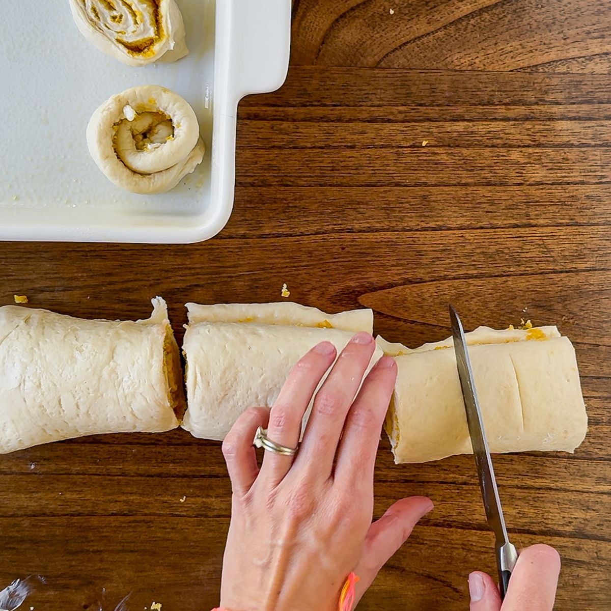 Cutting the orange rolls.