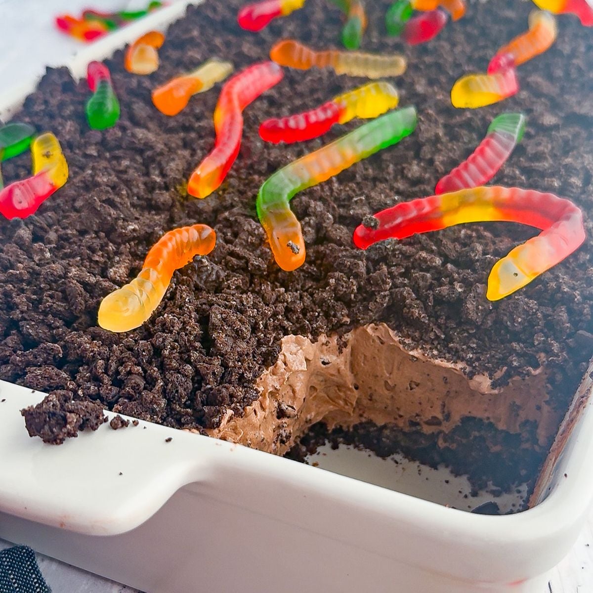 Top the dirt cake with gummy worms.