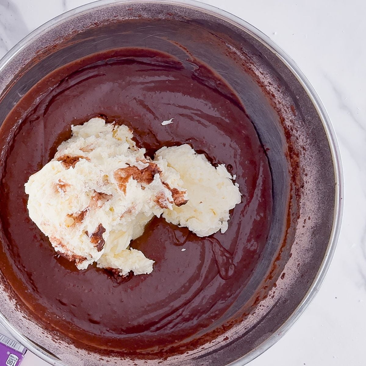 Adding the cream cheese to the pudding.