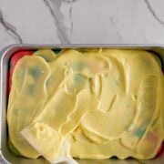 Spreading pudding on poke cake.