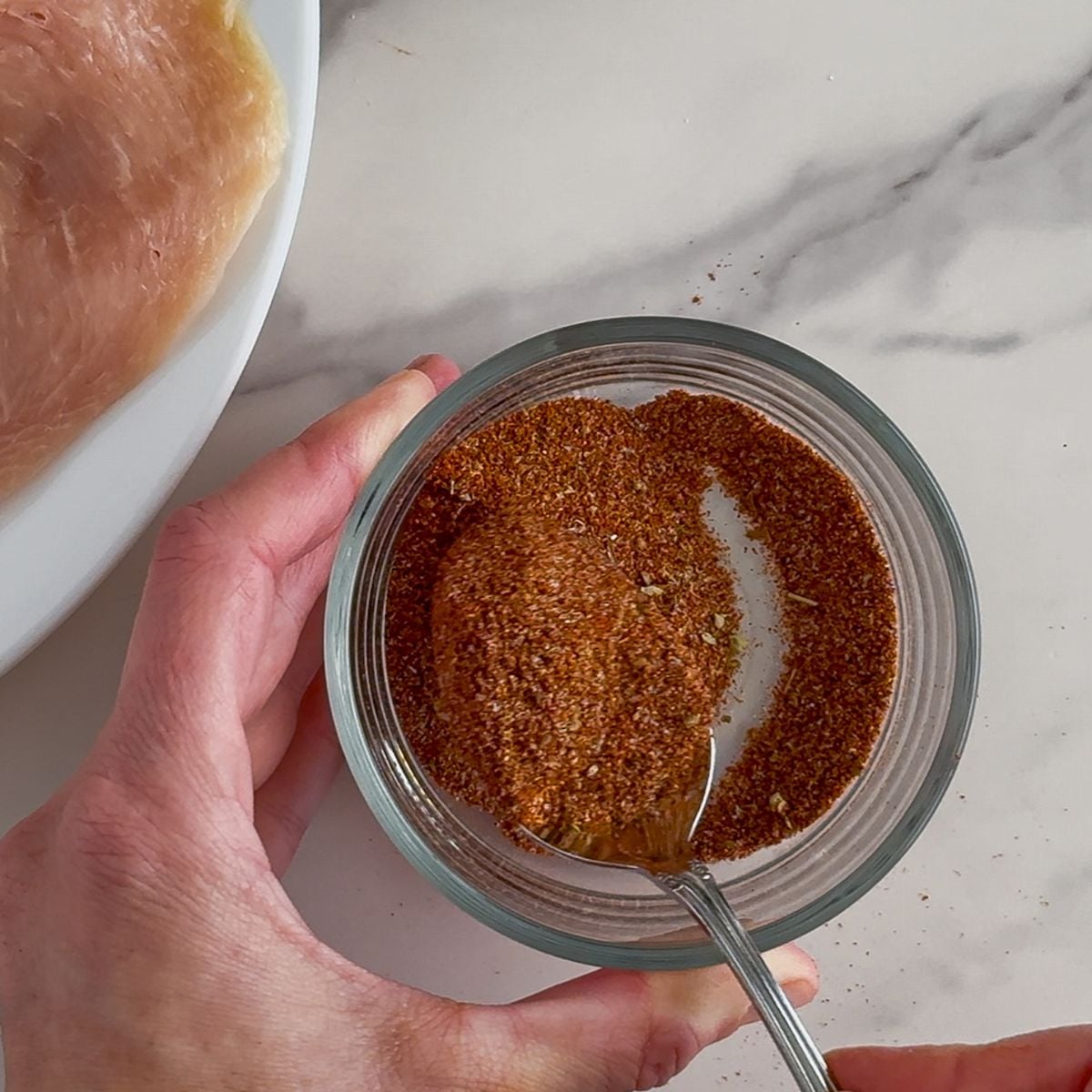 Mixing the seasoning in a bowl.