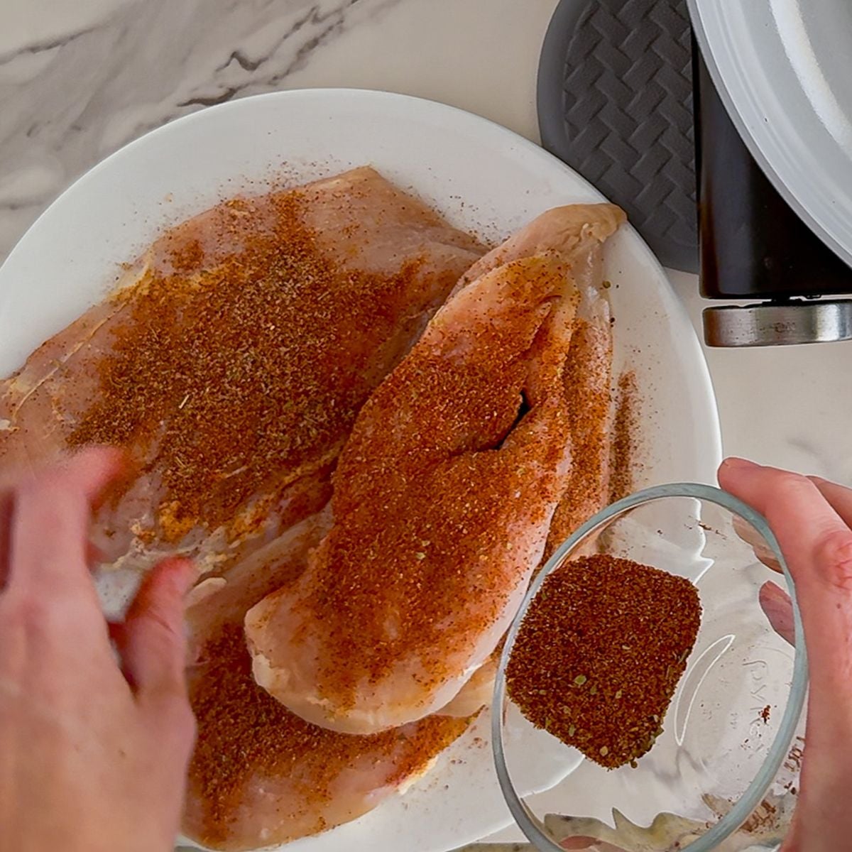 Seasoning the chicken.