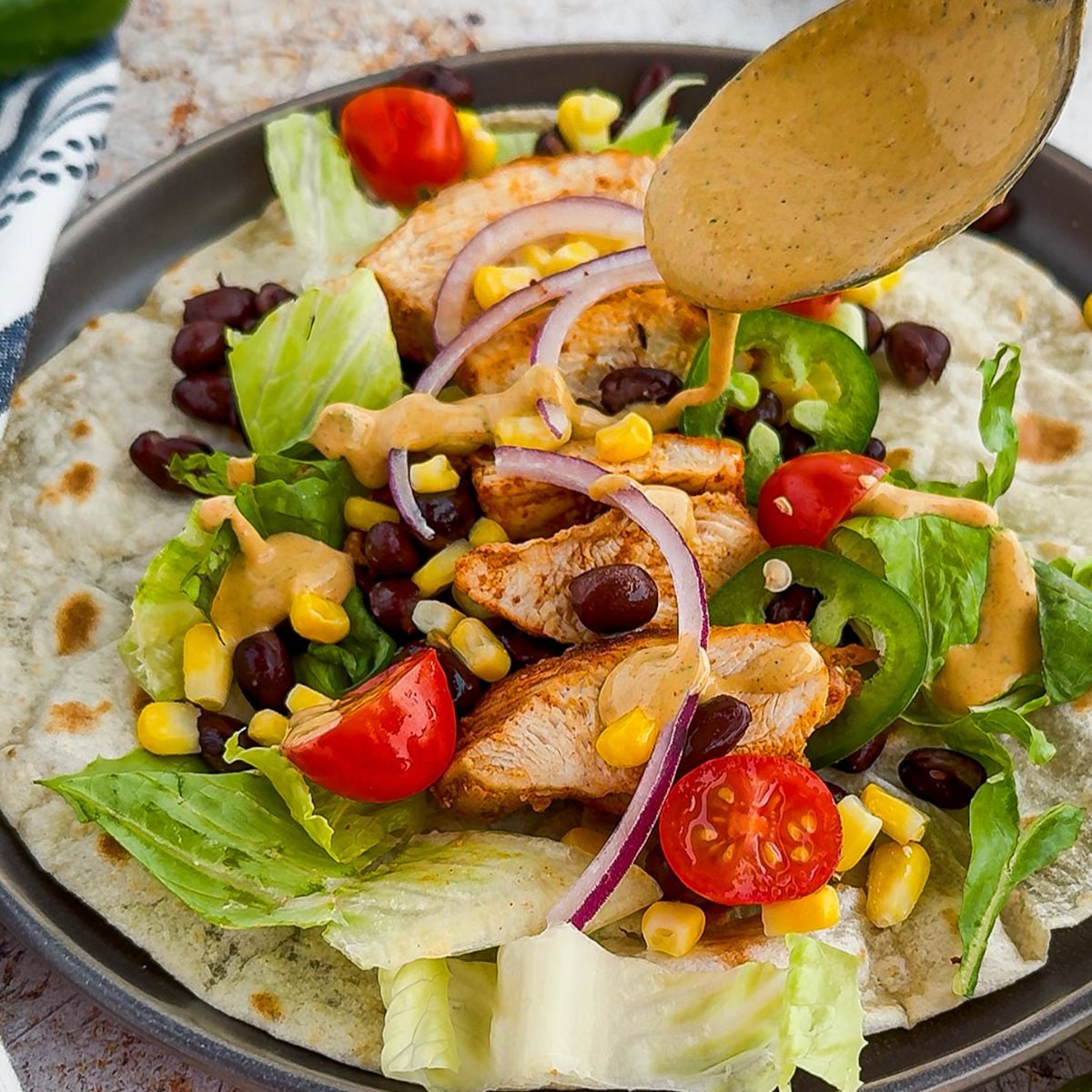 Assembling a southwest chicken wrap.