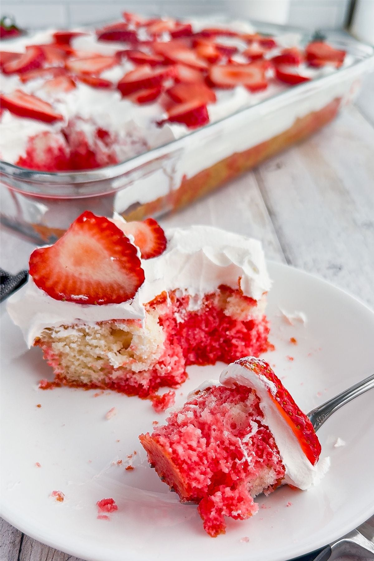 Slice of strawberry poke cake.