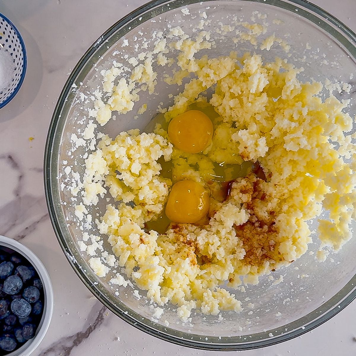 Adding the eggs to the creamed sugar and butter.