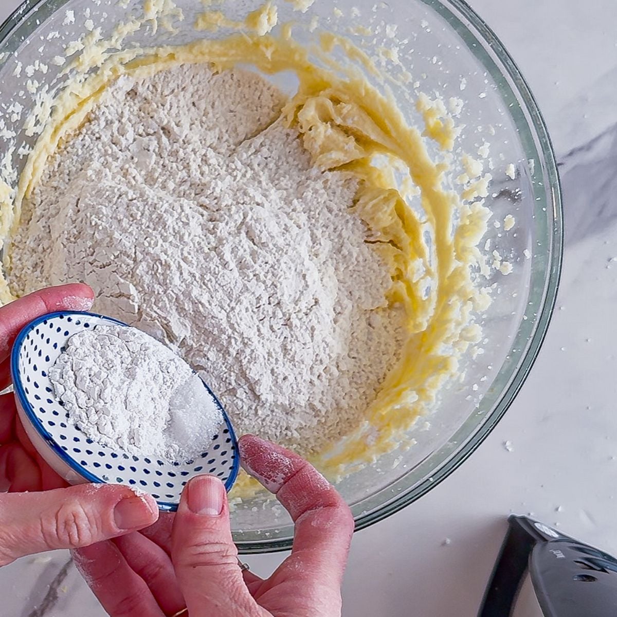 Adding the dry ingredients to the wet ingredients.
