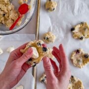 Folding cookie dough around cream cheese.