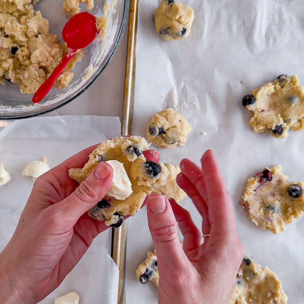 Folding cookie dough around cream cheese.