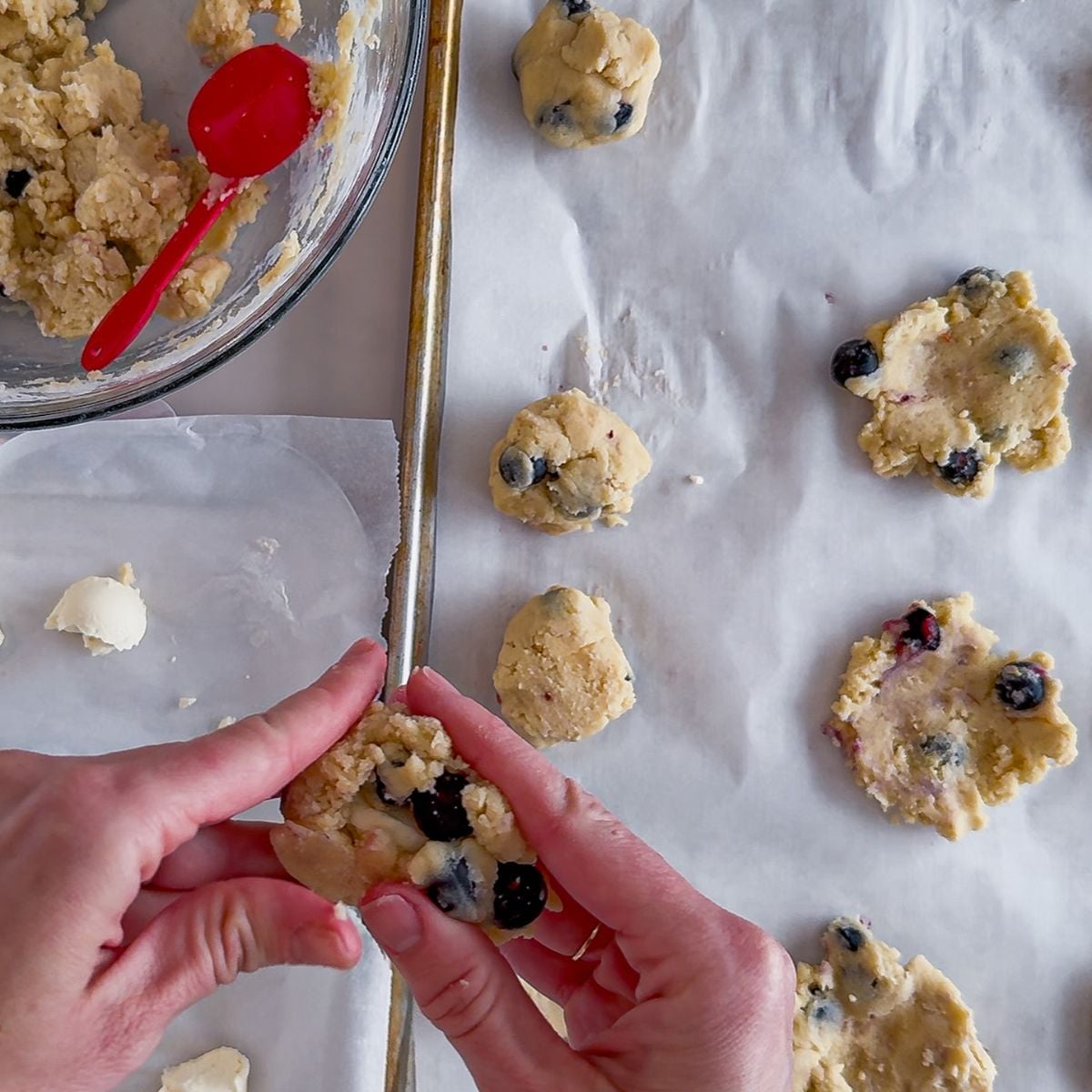 Pressing the cookie dough with cream cheese into a dough ball.