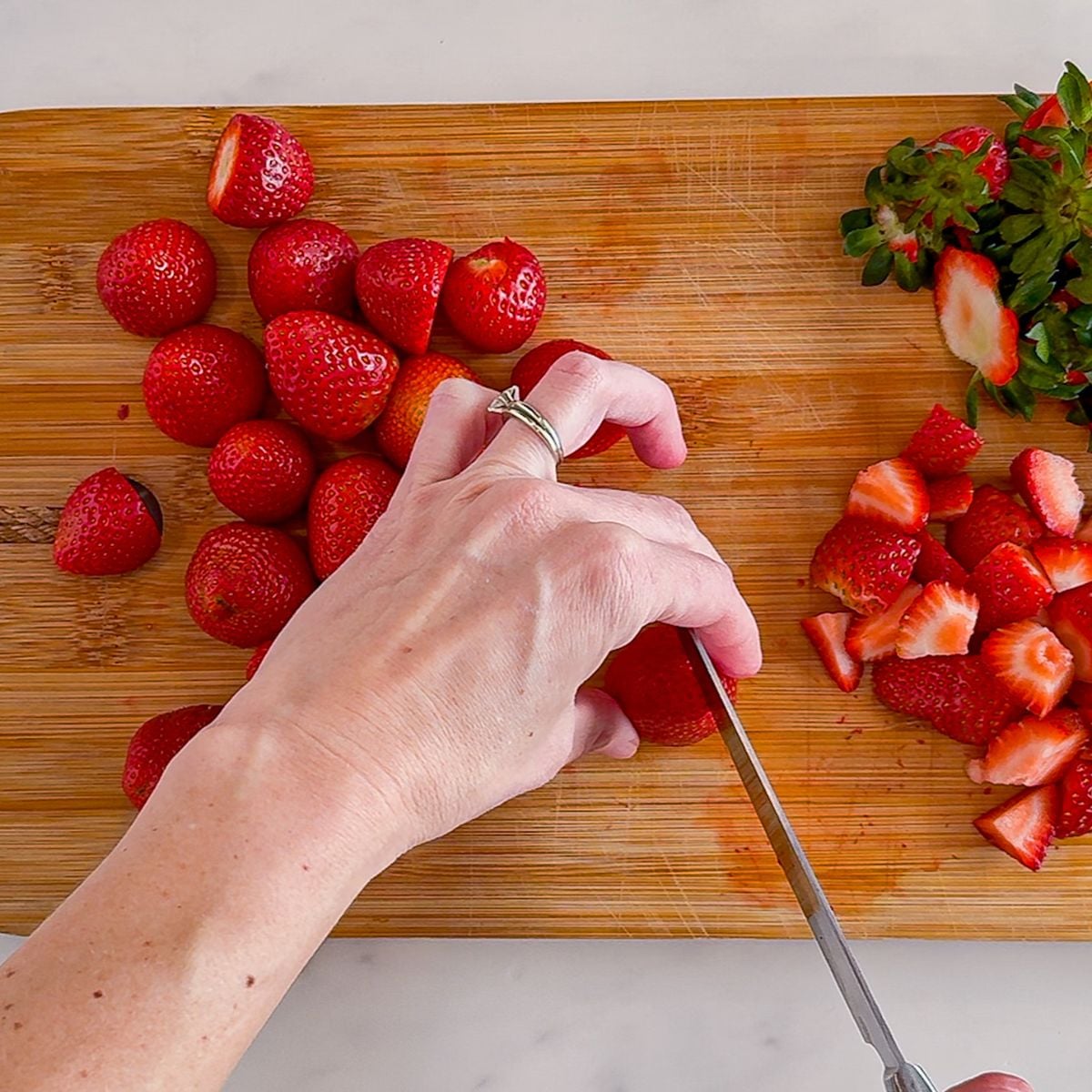 Chopping strawberries.