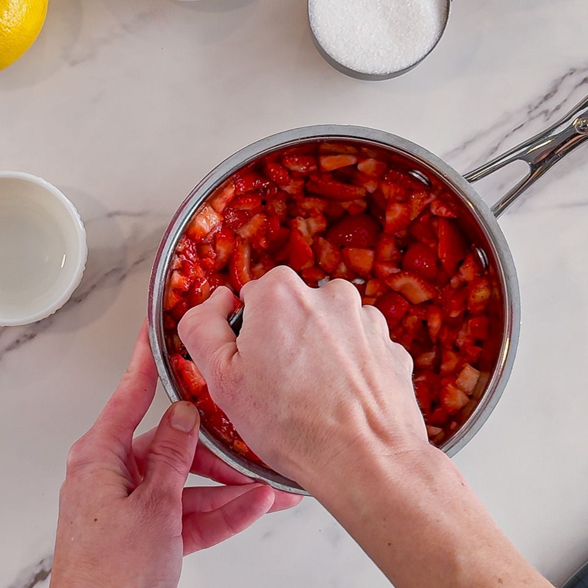 Mashing strawberries.