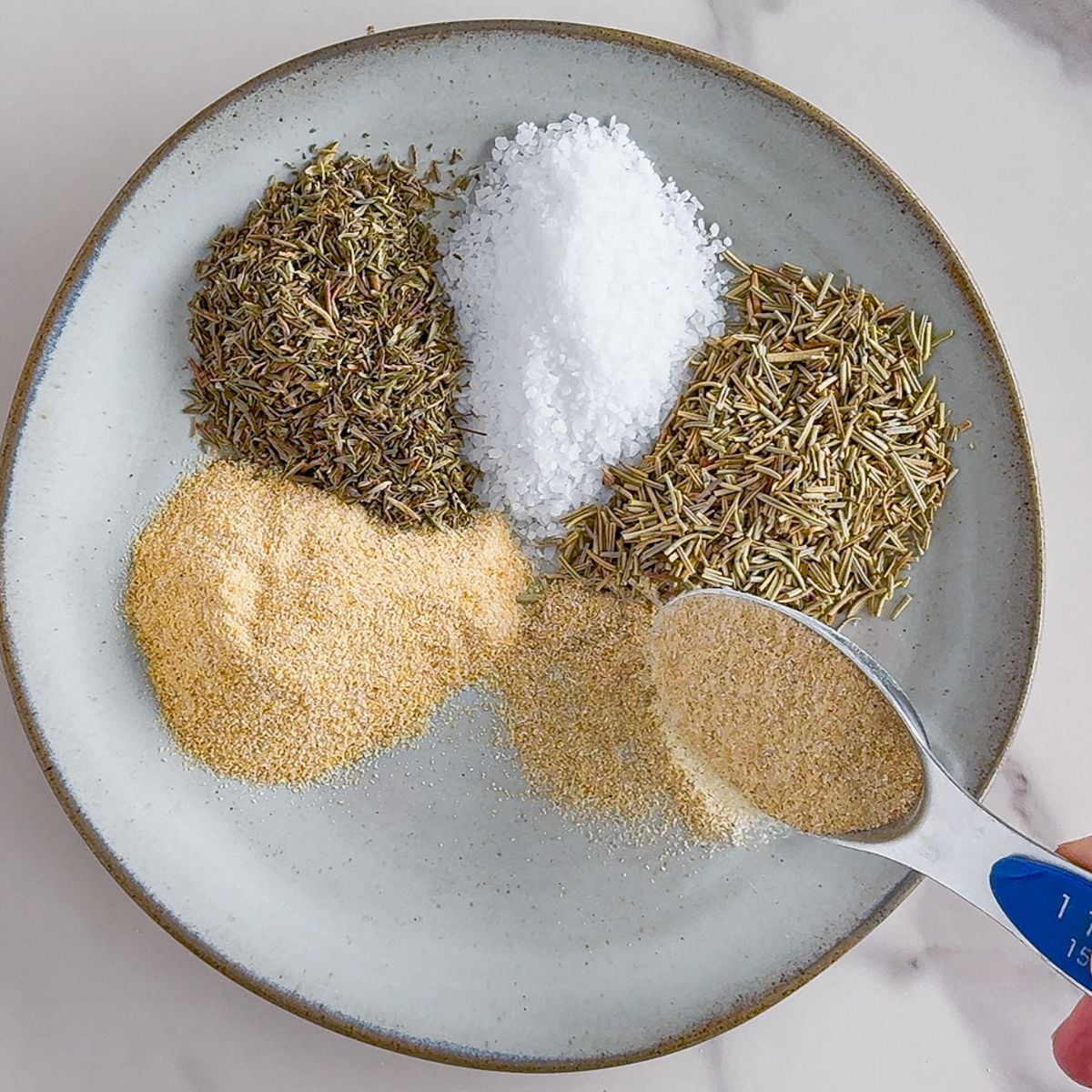 Adding turkey seasoning to a bowl.