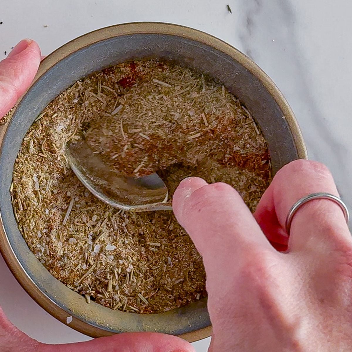 Mixing turkey seasoning.