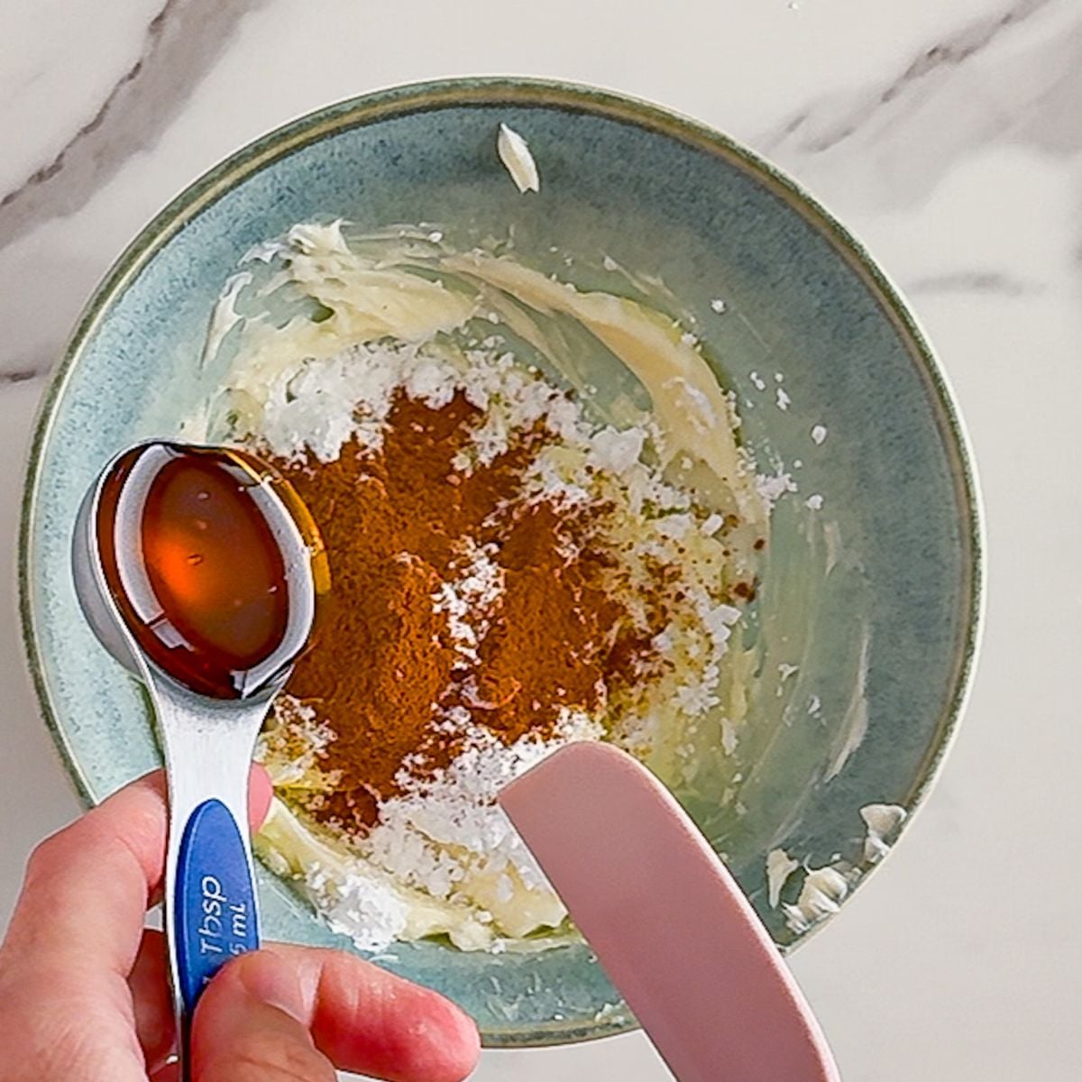 Adding honey to smooth butter.